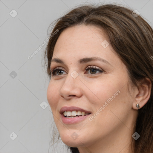 Joyful white young-adult female with long  brown hair and grey eyes