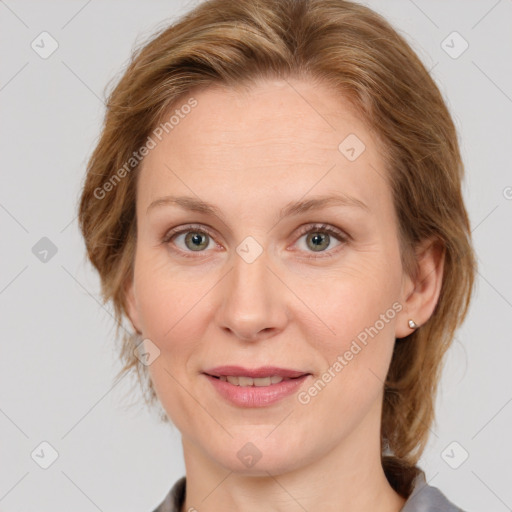 Joyful white adult female with medium  brown hair and blue eyes