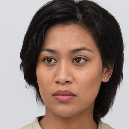 Joyful asian young-adult female with medium  black hair and brown eyes