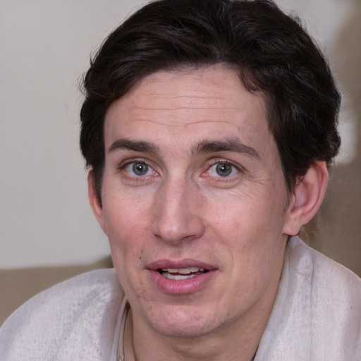 Joyful white adult male with medium  brown hair and brown eyes