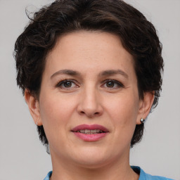 Joyful white adult female with short  brown hair and brown eyes