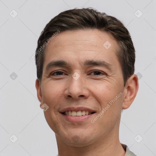 Joyful white adult male with short  brown hair and brown eyes