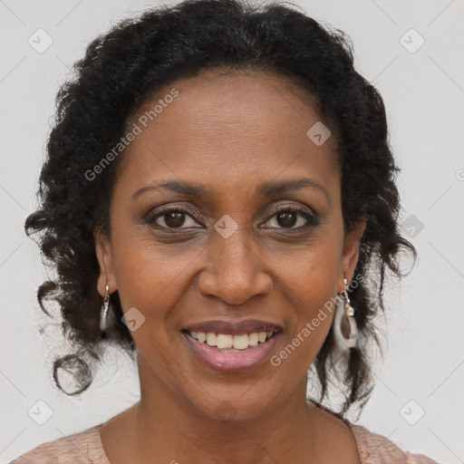 Joyful black adult female with long  brown hair and brown eyes