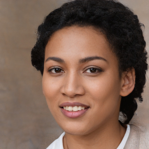 Joyful latino young-adult female with short  black hair and brown eyes