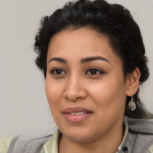 Joyful latino young-adult female with medium  black hair and brown eyes