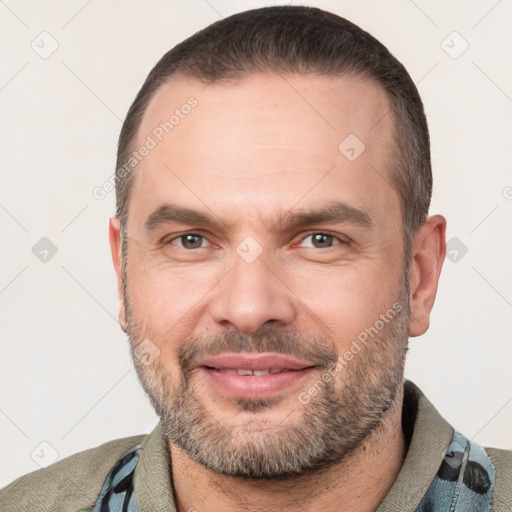 Joyful white adult male with short  brown hair and brown eyes