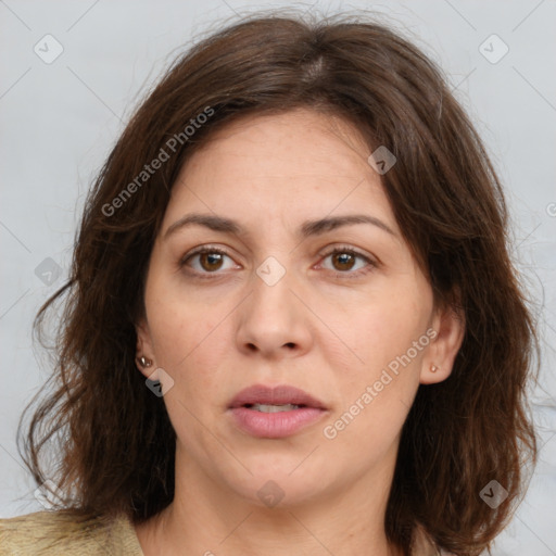 Joyful white adult female with long  brown hair and brown eyes