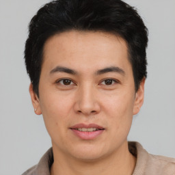 Joyful asian young-adult male with short  brown hair and brown eyes