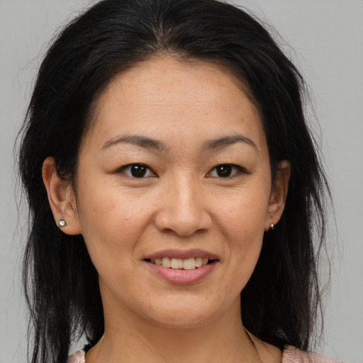 Joyful asian adult female with medium  brown hair and brown eyes