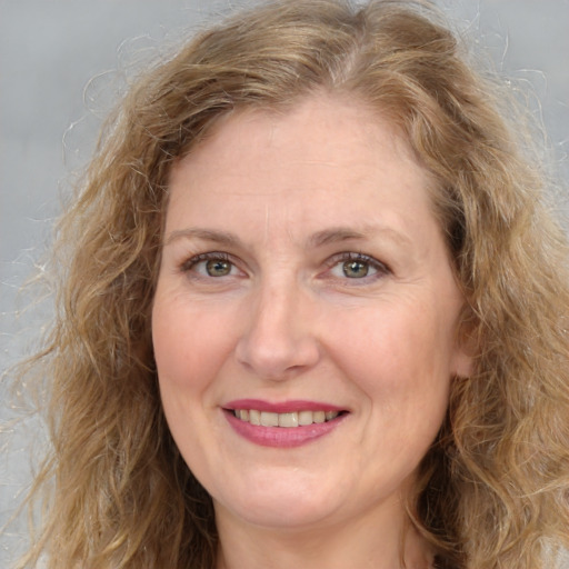 Joyful white adult female with long  brown hair and brown eyes