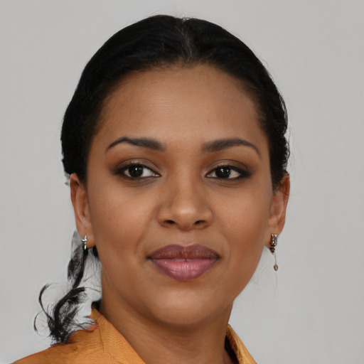 Joyful black young-adult female with short  black hair and brown eyes