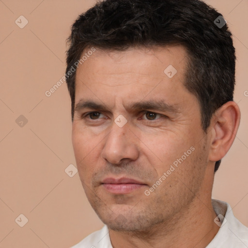 Joyful white adult male with short  black hair and brown eyes