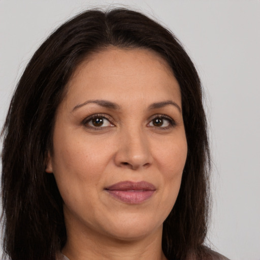 Joyful white adult female with long  brown hair and brown eyes