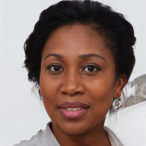 Joyful black adult female with medium  black hair and brown eyes