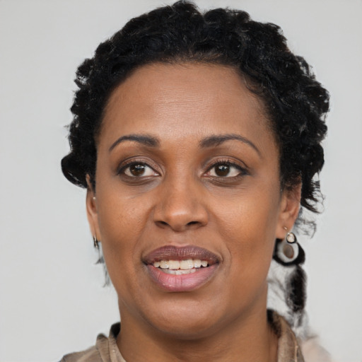 Joyful black adult female with short  brown hair and brown eyes