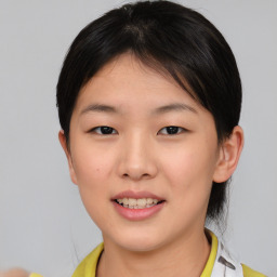 Joyful asian young-adult female with short  brown hair and brown eyes