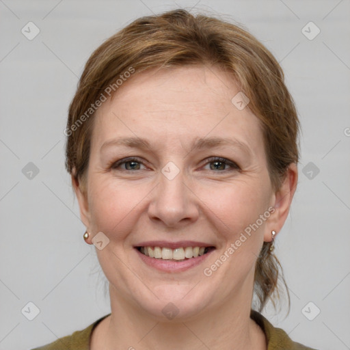 Joyful white adult female with short  brown hair and grey eyes