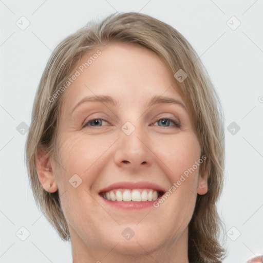 Joyful white adult female with medium  brown hair and grey eyes