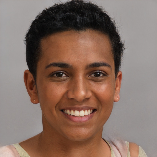 Joyful black young-adult female with short  brown hair and brown eyes