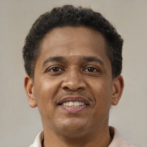 Joyful black young-adult male with short  brown hair and brown eyes