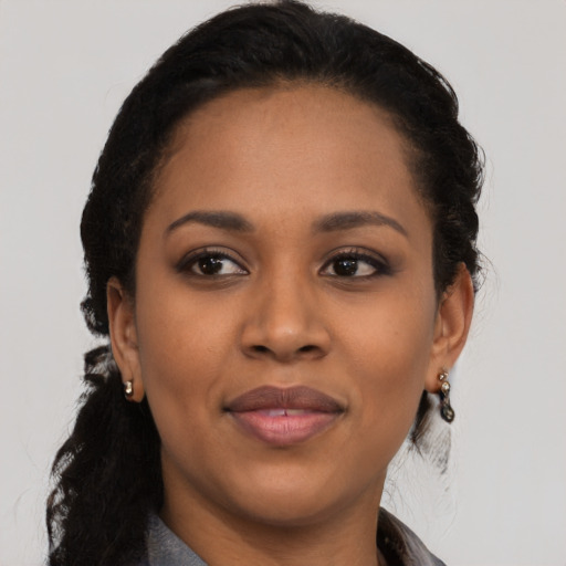 Joyful latino young-adult female with short  black hair and brown eyes