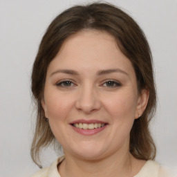 Joyful white young-adult female with medium  brown hair and brown eyes