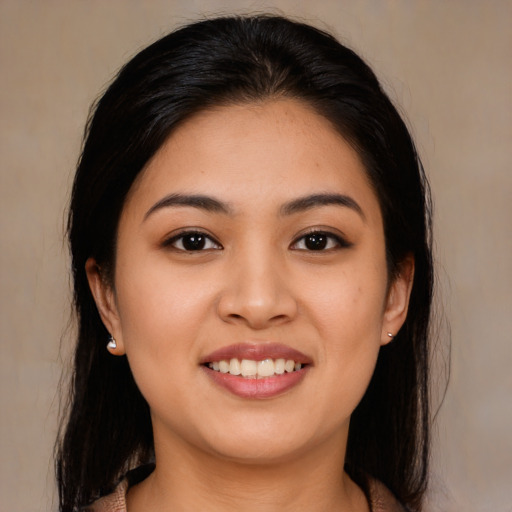 Joyful asian young-adult female with long  brown hair and brown eyes