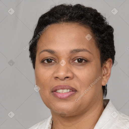 Joyful black adult female with short  brown hair and brown eyes