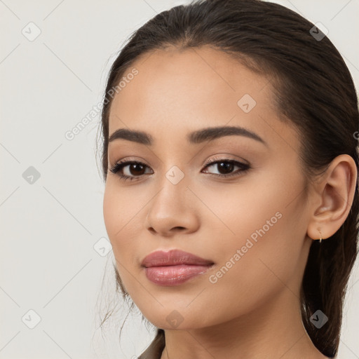 Joyful latino young-adult female with long  brown hair and brown eyes