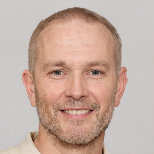 Joyful white adult male with short  brown hair and grey eyes