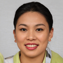 Joyful asian young-adult female with medium  brown hair and brown eyes