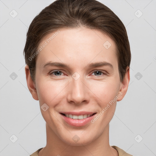 Joyful white young-adult female with short  brown hair and grey eyes