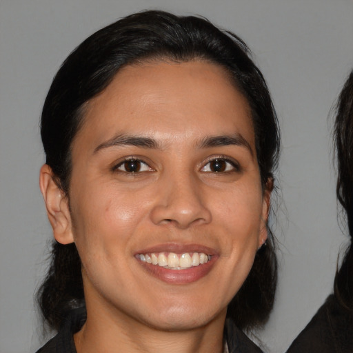 Joyful white young-adult female with medium  brown hair and brown eyes