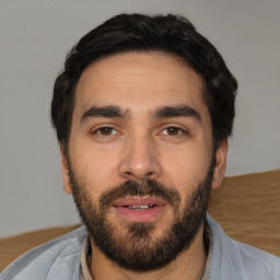 Joyful white young-adult male with short  black hair and brown eyes