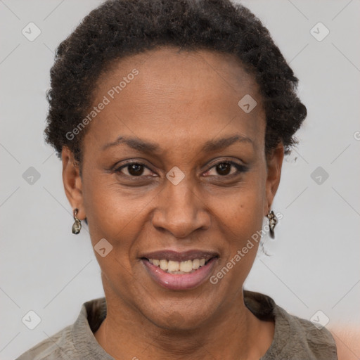 Joyful black adult female with short  brown hair and brown eyes