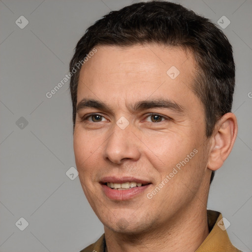 Joyful white adult male with short  brown hair and brown eyes