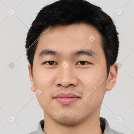 Joyful asian young-adult male with short  black hair and brown eyes