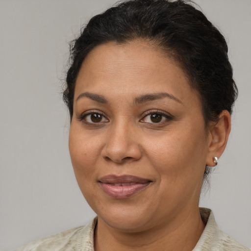 Joyful latino adult female with short  brown hair and brown eyes