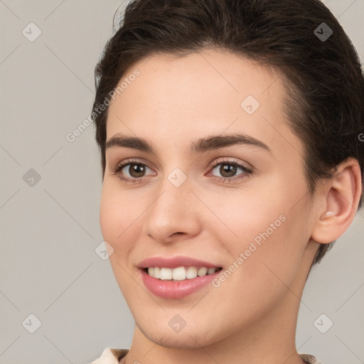 Joyful white young-adult female with short  brown hair and brown eyes