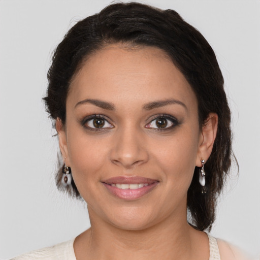 Joyful latino young-adult female with medium  brown hair and brown eyes