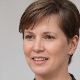 Joyful white adult female with medium  brown hair and brown eyes