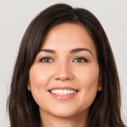 Joyful white young-adult female with long  brown hair and brown eyes