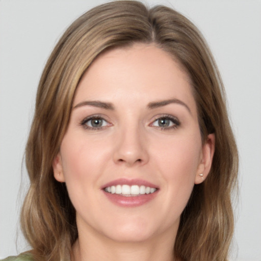 Joyful white young-adult female with medium  brown hair and green eyes