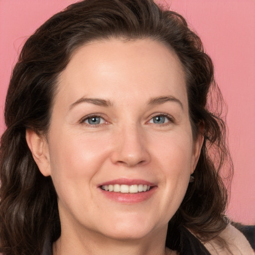 Joyful white adult female with medium  brown hair and grey eyes