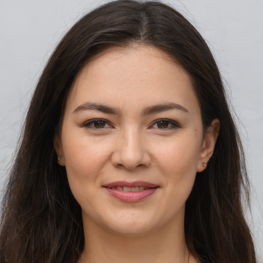 Joyful white young-adult female with long  brown hair and brown eyes