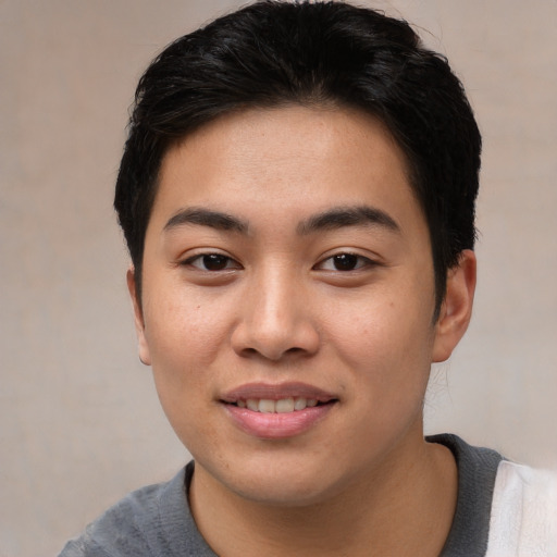 Joyful asian young-adult male with short  black hair and brown eyes