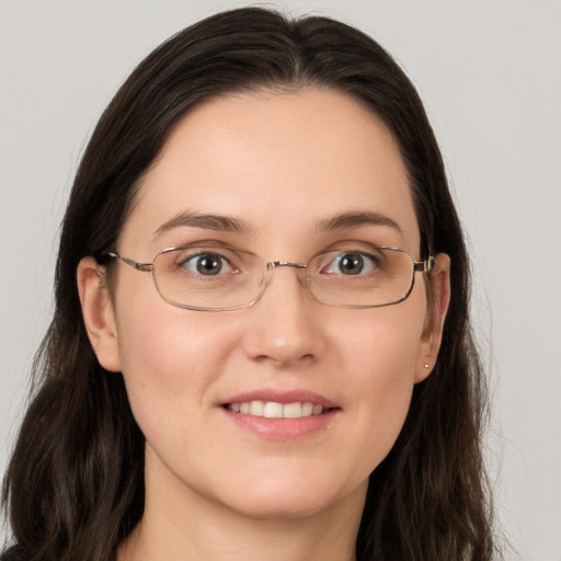 Joyful white young-adult female with long  brown hair and grey eyes