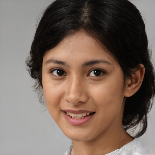 Joyful latino young-adult female with medium  brown hair and brown eyes