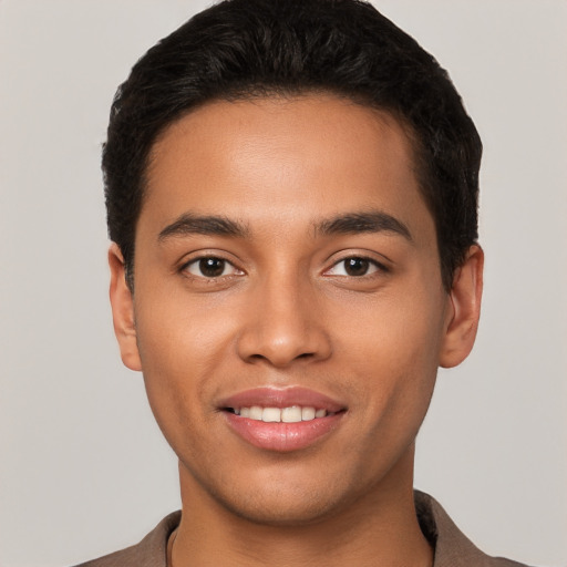 Joyful latino young-adult male with short  black hair and brown eyes