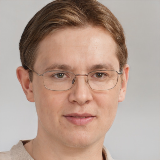 Joyful white adult male with short  brown hair and grey eyes